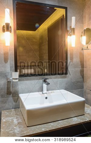Washbasin With Mirrow In The Hotel Bathroom