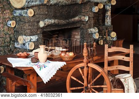 Variety Of Food Ingredients For Bread Baking Along With Retro Spinning Wheel Placed On Table In Coun