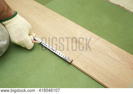 Installation Laminate Or Parquet In The Room, Worker Installing Wooden Laminate Flooring, Marking Th