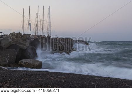 Boats In Vlichada Harbor On Santorini Island In Greece In The Morning At Sunrise. The Background Is 
