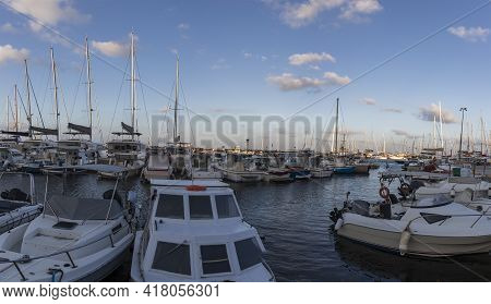 Boats In Vlichada Harbor On Santorini Island In Greece In The Morning At Sunrise. The Background Is 