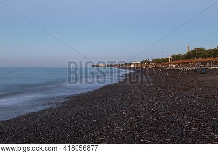 Beautiful Black Beach With Coast And Sea In Vlichada With Blue Sky Background With White Clouds And 