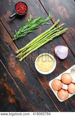Fresh Asparagus Eggs And French Dressing Ingredients With Dijon Mustard, Onion Taragon On Dark Woode