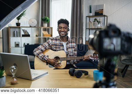 Inspired Afro Man Playing Guitar And Recording Music Video For His Social Networks. Happu Musician S