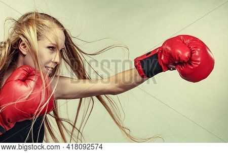 Bloned Long Hair Girl Boxer In Big Fun Red Gloves Playing Sports Boxing. Female Fight For Equal Righ