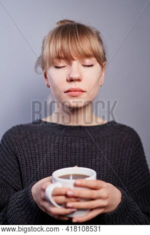 Dreaming Or Positive Thinking Concept. Attractive Caucasian Blonde Woman In Black Sweater Holding Cu