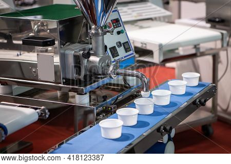 Cream Filling Machine In Bakery Processing. Food Depositor Machine. Food Industry