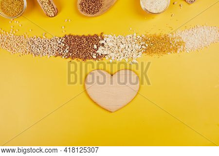 Flat Lay Of Set Of Heap Various Grains And Cereals On Yellow Background