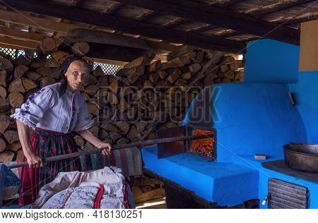 Salaj, Transylvania, Romania-may 14, 2018: Local Old Woman In Traditional Romanian Folk Costume Prep