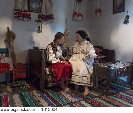 Salaj,transylvania,romania-may 14, 2018: Mother Teaching His Young Girl In Traditional Romanian Folk