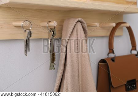 Wooden Hanger For Keys On Light Grey Wall, Closeup