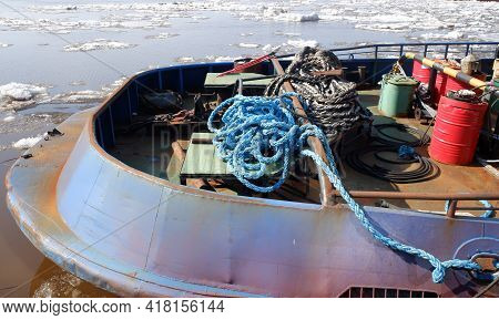 Part Of The Stern Of The Tug With Different Ropes And A Barrel Against The Background Of The Severna