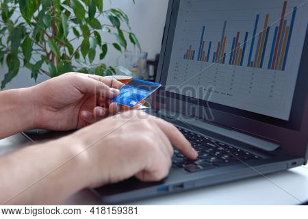 Businessman Makes A Purchase On Internet And Points His Finger At The Cvv Code. Online Payment And  