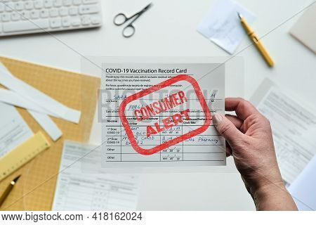Fake Covid Vaccination Record Card. Covid Scams. Forged Health Certificate With False Vaccination Re