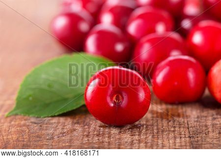 Cherries On Wooden Table With Water Drops Macro Background
