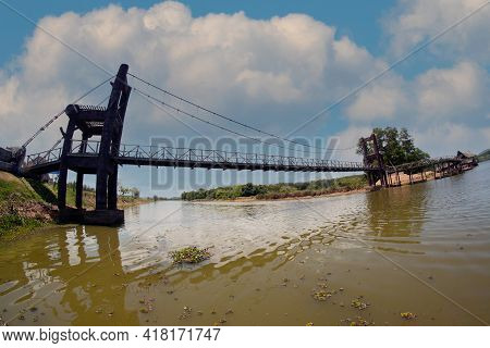 Wooden Suspension Bridge That Crosses A Reservoir In A Public Park In Thailand.