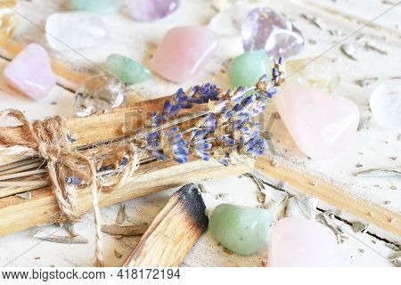 A Close Up Image Of Palo Santo Incense Sticks With Dried Lavender And Healing Crystals On A White Ba