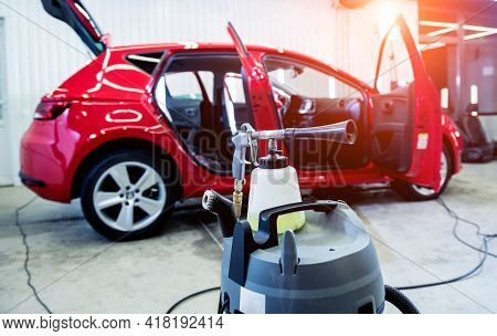 A Car Service Worker Cleans Interiror With A Special Foam Generator