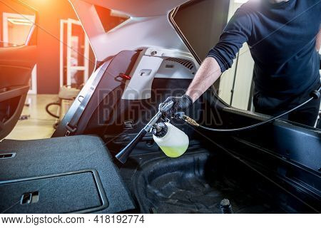 A Car Service Worker Cleans Interiror With A Special Foam Generator