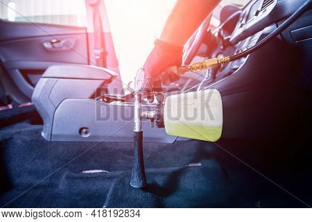 A Car Service Worker Cleans Interiror With A Special Foam Generator