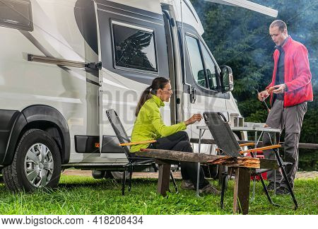 Caucasian Couple During Their Vacation. Modern Recreational Vehicle Rv Camper Van Road Trip With Cam