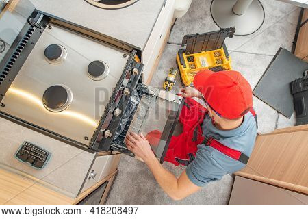 Caucasian Rv Technician In His 40s Replacing Broken Travel Trailer Gas Stove. Camper Appliances.