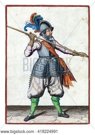 A soldier, full-length, carrying a spear (lance) above his right shoulder, the point pointing obliquely towards the ground. His hands wide apart on the skewer