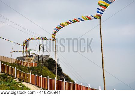 Yellow And White Iron Fencing With Flying Prayer Flags
