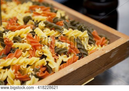 Raw Homemade Tricolor Fusilli Pasta In A Basket.