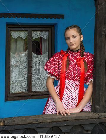 Salaj, Transylvania, Romania-may 14, 2018: Beautiful Young Girl In Traditional Costume Sitting On Th