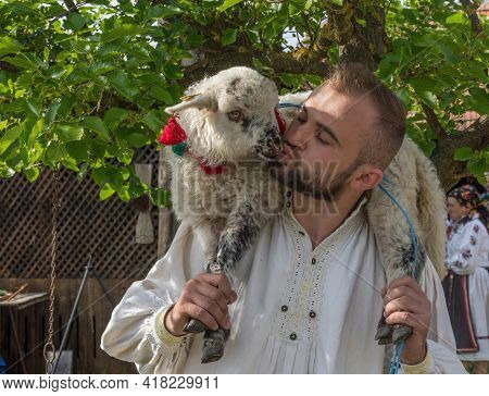 Salaj, Transylvania, Romania-may 14, 2018: Young Man In Traditional Romanian Folk Costume Holding An