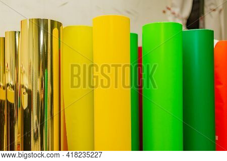 Row Of Various Colored Vinyl Car Wrapping Or Plotter Cutting Sticker Foil Film Rolls