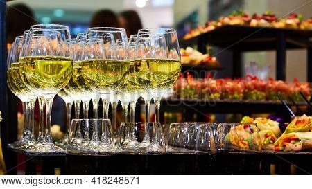 Glasses Of White Wine Are On The Table, Ready To Serve.