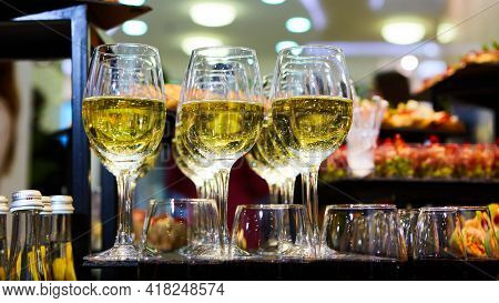 Glasses Of White Wine Are On The Table, Ready To Serve.