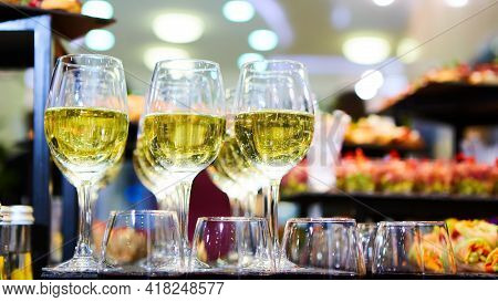 Glasses Of White Wine Are On The Table, Ready To Serve.