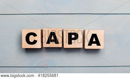 Wooden Cubes With The Text Capa On A Light Blue Wooden Background.