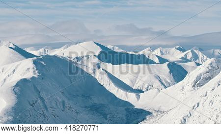 Snowy Landscape In The Winter Season. Snow-covered Mountains Against The Cloudy Sky. High Quality Ph