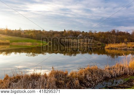 quiet sunset over vollage lake at spring time
