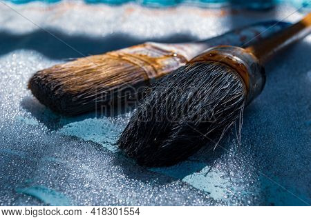 Close Up Of Two Old And Rusty Paintbrushes