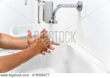 Hand Of Man Wash Your Hands At The Wash Basin With Foam, Cleanse The Skin And Have Water Flowing Thr