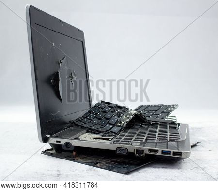 The Laptop Is Smashed To Pieces. The Screen Is Cracked, The Keyboard Is Broken. Electro Waste.