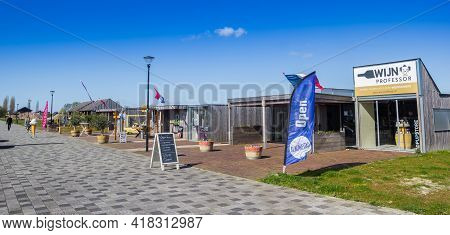 Blauwestad, Netherlands - April 24, 2021: Panorama Of Little Shops In The Harbor Ditrict Of Blauwest