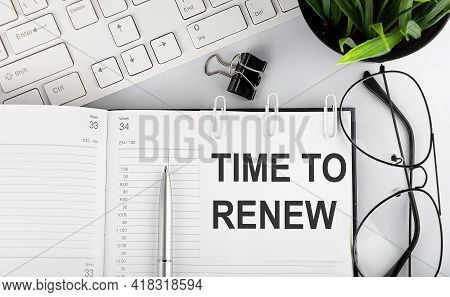 Text Time To Renew On White Stickers On Notebook With Keyboard And Glasses.