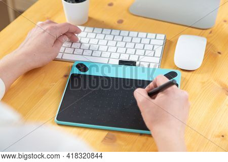 Hand Of Graphic Designer Working With Stilus And Tablet