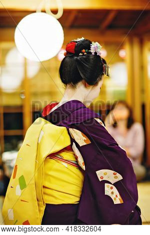 Maiko Apprentice Showing Japanese Traditional Dance. Maiko Is An Apprentice Geisha. Maikos Performin