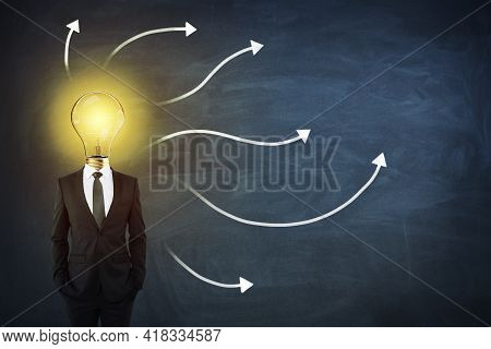 Sturtup And Idea Concept With Man In Black Suit With Light Bilb On Shoulders On Blackboard With Whit