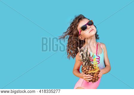 Beautiful Girl In Colorful Swimsuit And Sunglasses Holding Pinea