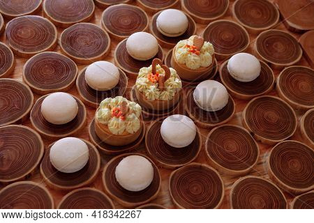 White Delicate Lowly Macaroons On A Wooden Background. The Pastel Tone Of The Cream Inside The Frenc