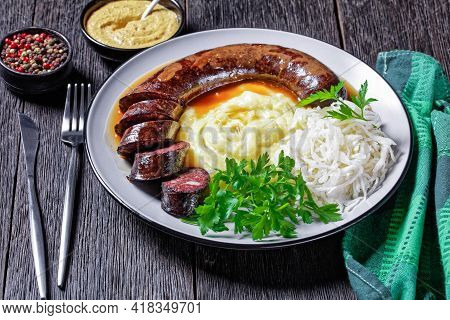 German Food: Blutwurst Or Blood Sausage Served On A Plate With Sauerkraut, Mashed Potato Parsley, Mu