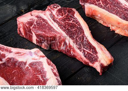 Dry-aged Raw T-bone Or Porterhouse Beef Meat Steak Set, On Black Wooden Table Background